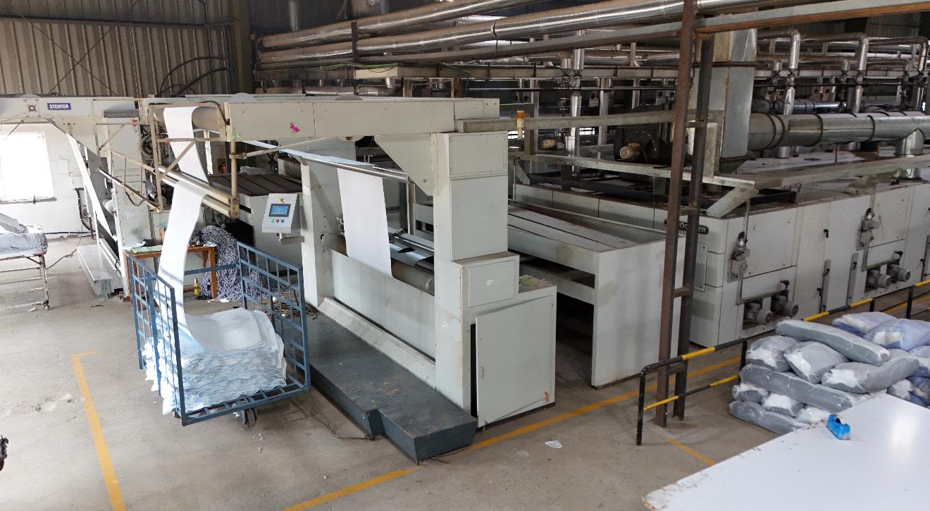 Stenter and compacting line where fabric shrinkage and spirality are controlled