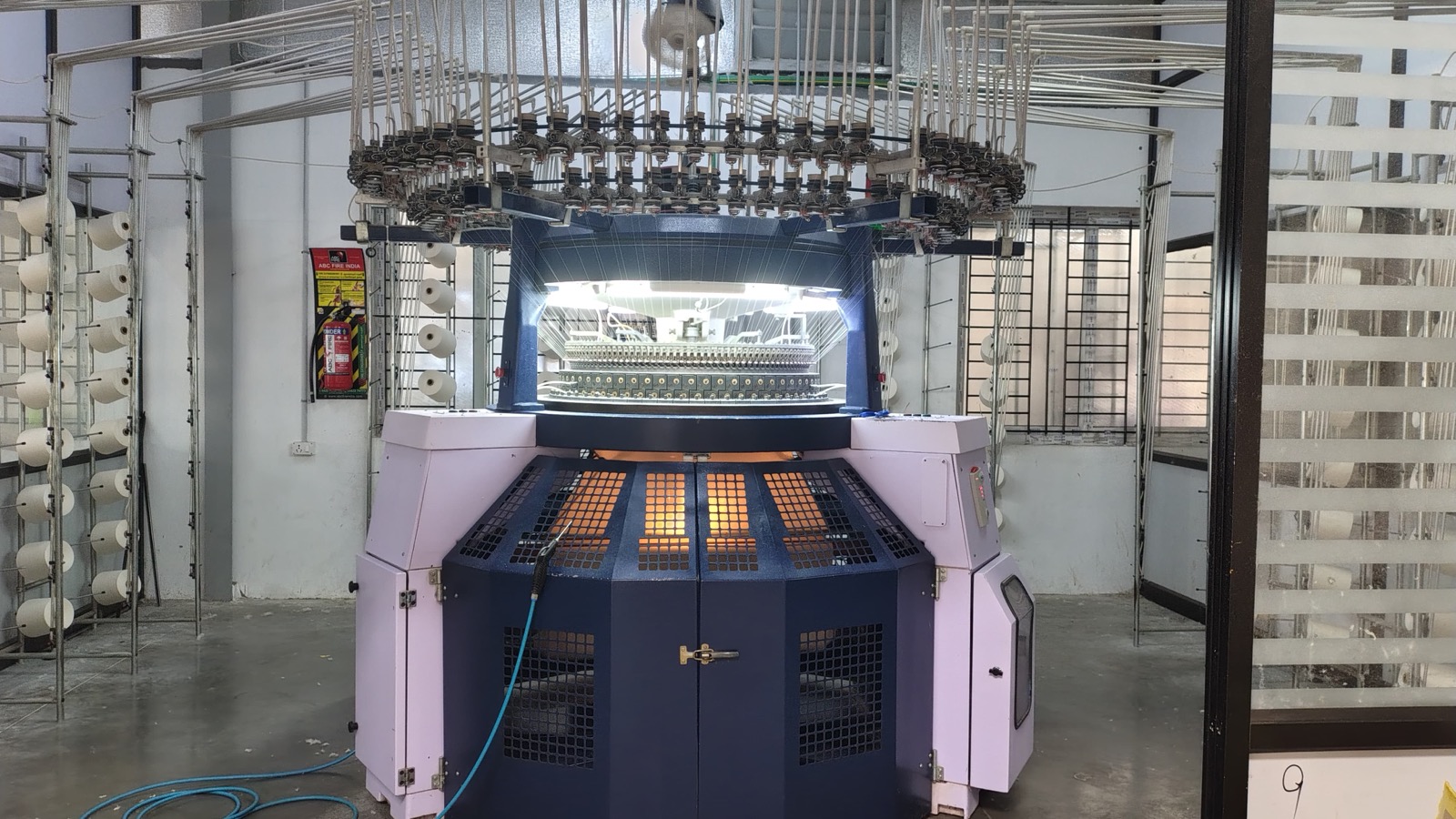 Circular knitting machine with yarn creel running greige fabric in our knitting unit