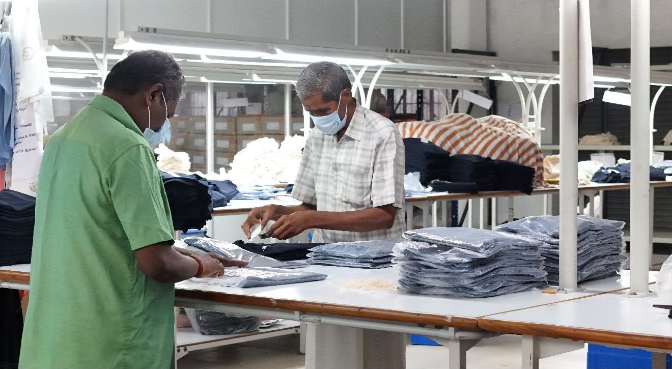 Packing section staff polybagging and labelling finished garments for export